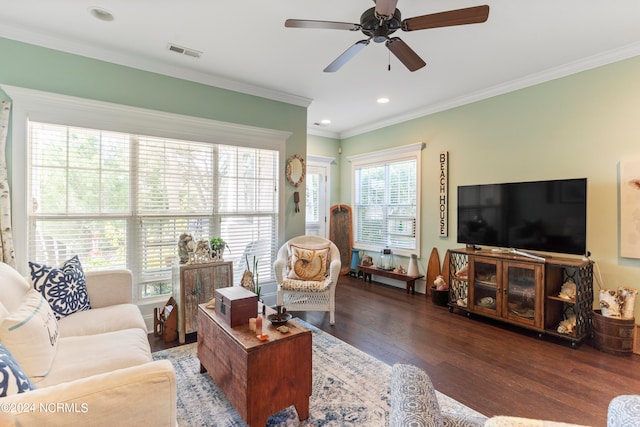 living room with ornamental molding, dark wood-type flooring, and ceiling fan