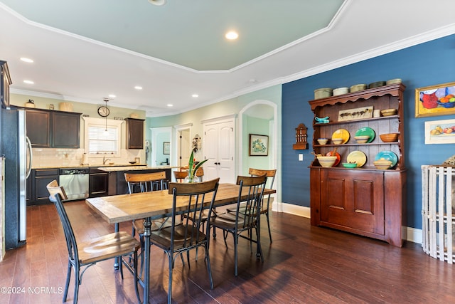 dining room featuring crown molding and dark wood-type flooring