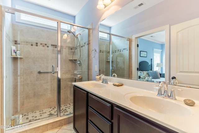 bathroom with a shower with door, tile patterned flooring, vanity, and plenty of natural light