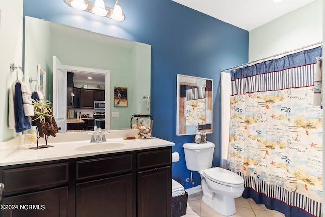 bathroom featuring vanity, tile patterned flooring, and toilet