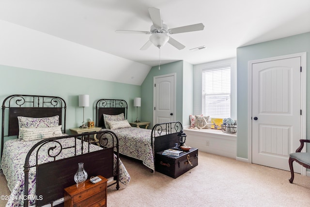 carpeted bedroom featuring lofted ceiling and ceiling fan