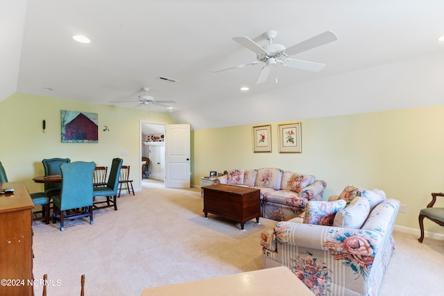 carpeted living room featuring vaulted ceiling and ceiling fan