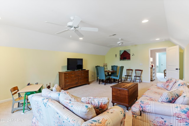 living room featuring lofted ceiling, ceiling fan, and light colored carpet