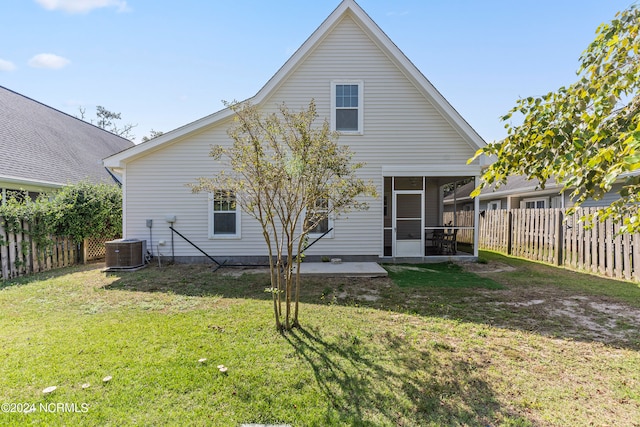 rear view of property featuring a yard and a sunroom