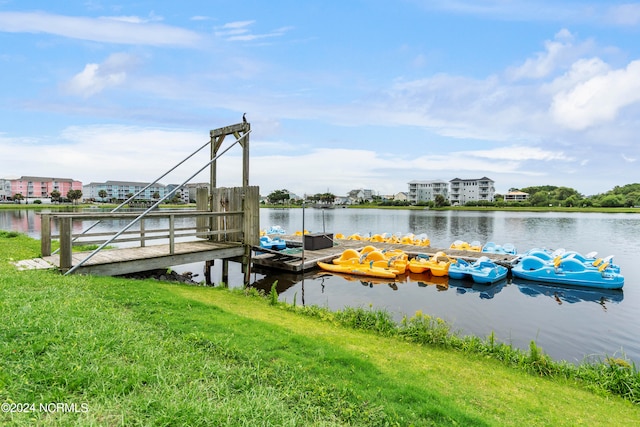 dock area featuring a lawn and a water view