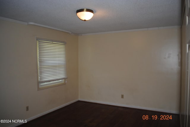 unfurnished room with a textured ceiling, hardwood / wood-style floors, and ornamental molding