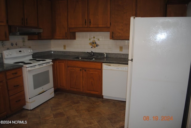 kitchen featuring brown cabinets, backsplash, a sink, white appliances, and under cabinet range hood