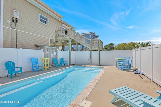 view of pool with a fenced backyard, a fenced in pool, and a patio