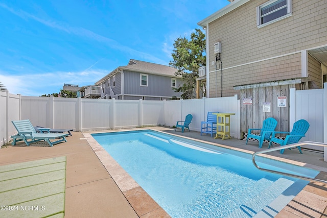 view of pool featuring a patio area, a fenced backyard, and a fenced in pool