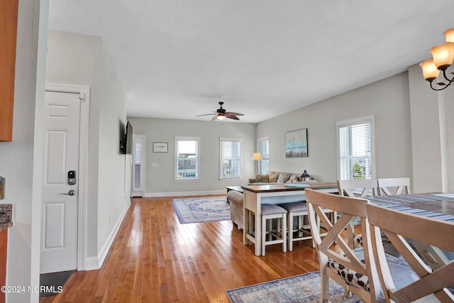 dining room featuring ceiling fan, light wood-type flooring, and baseboards