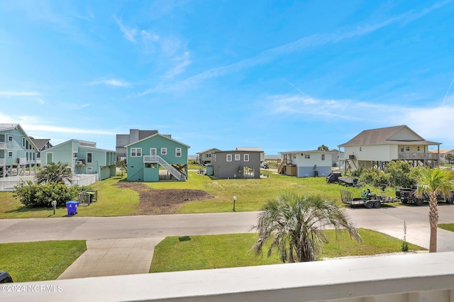 view of yard featuring stairs and a residential view