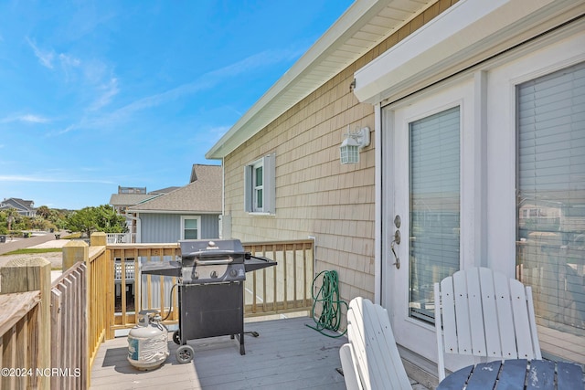 wooden terrace featuring grilling area