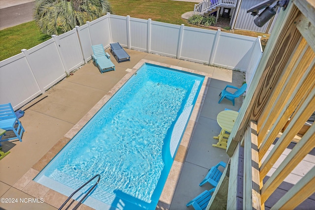 view of swimming pool featuring a yard and a fenced backyard