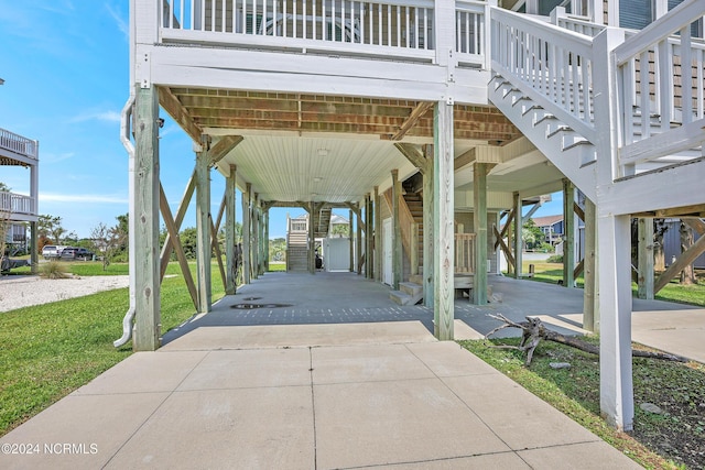 view of patio featuring a carport and stairway