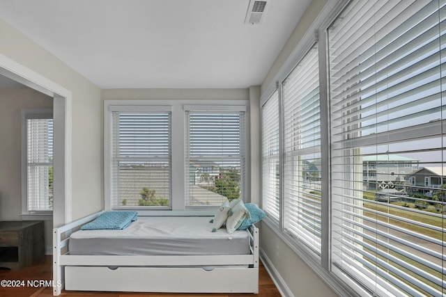 interior space with dark wood-style floors, visible vents, and baseboards