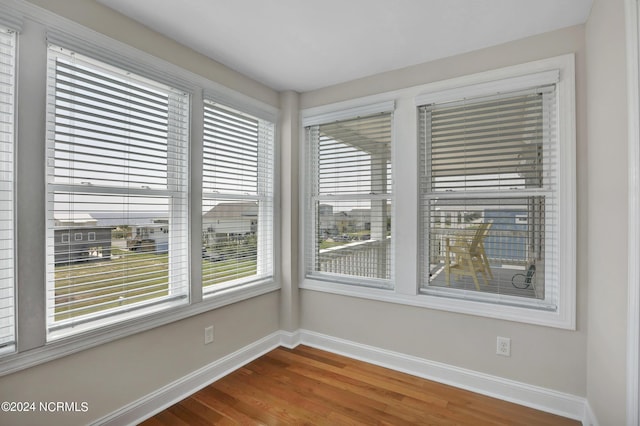 empty room featuring baseboards and wood finished floors