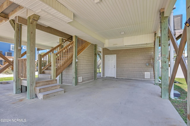 view of patio featuring a carport and stairway