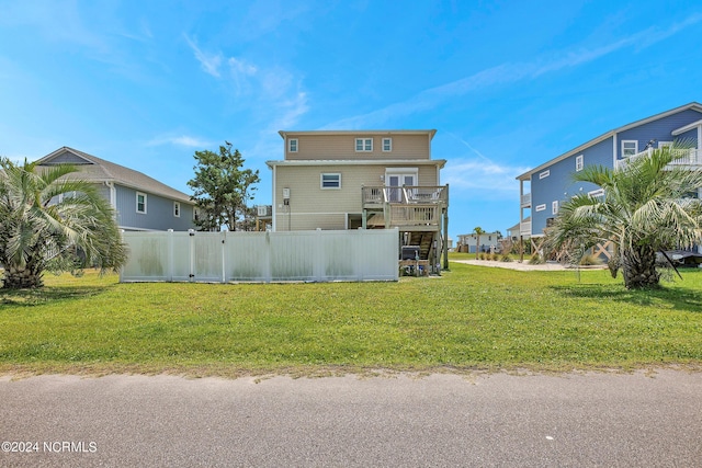 back of house with a lawn, fence, and a residential view