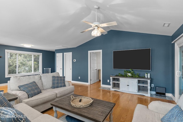 living room featuring ceiling fan, light hardwood / wood-style floors, and lofted ceiling