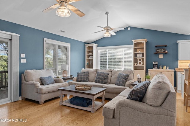 living room featuring ceiling fan, vaulted ceiling, and light hardwood / wood-style flooring