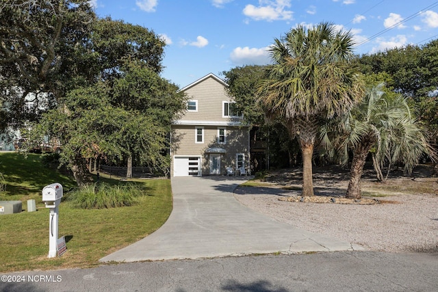 view of front of property with a garage and a front lawn