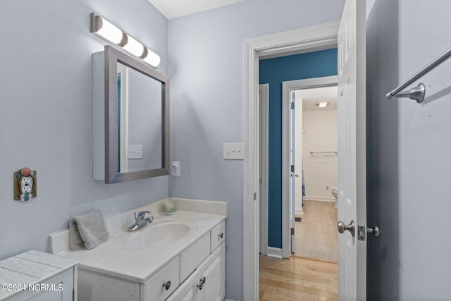 bathroom with hardwood / wood-style floors and vanity