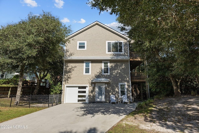 view of front of property featuring a balcony and a garage