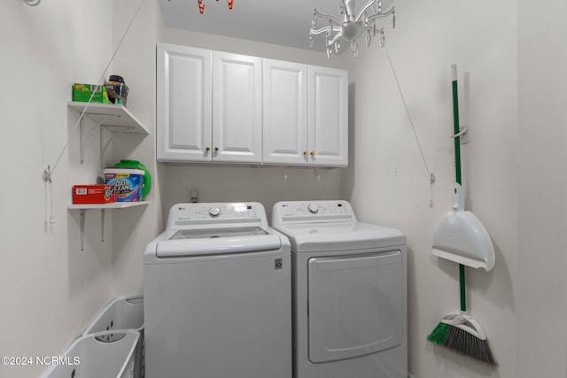 laundry area with cabinets, separate washer and dryer, and a chandelier