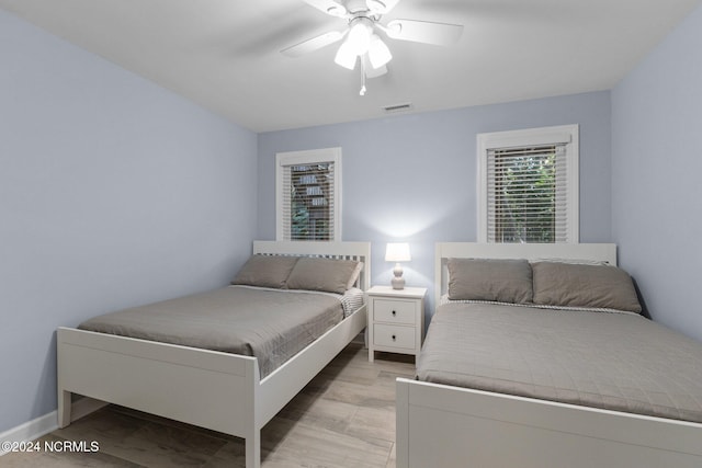 bedroom with light hardwood / wood-style flooring and ceiling fan