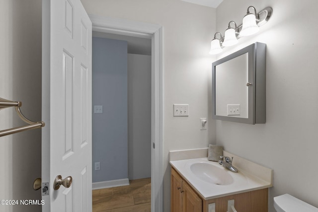 bathroom featuring tile patterned floors, toilet, and vanity