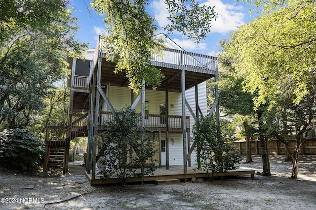 rear view of property with a wooden deck