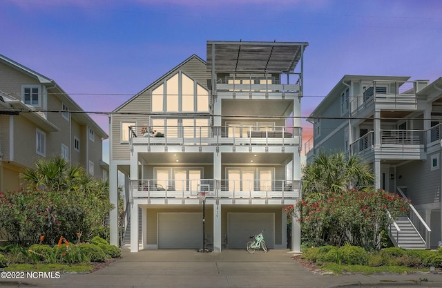 view of front of home with a balcony and a garage