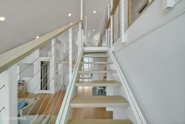 staircase featuring recessed lighting and wood finished floors