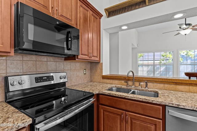 kitchen with ceiling fan, appliances with stainless steel finishes, sink, and backsplash