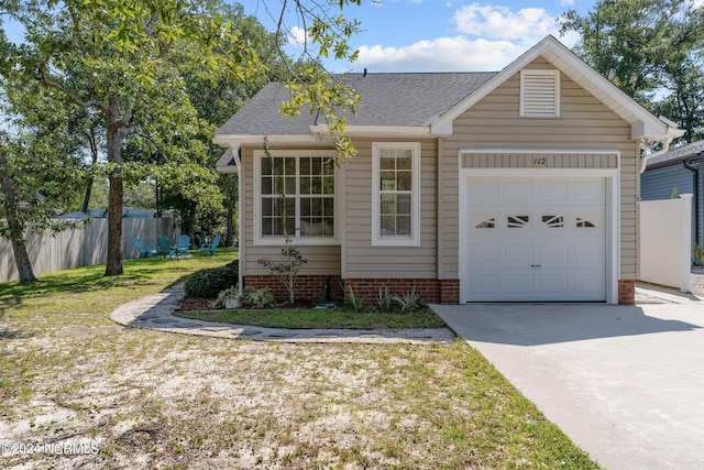 view of front of house featuring a garage and a front yard