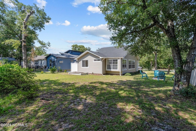 back of property featuring a yard