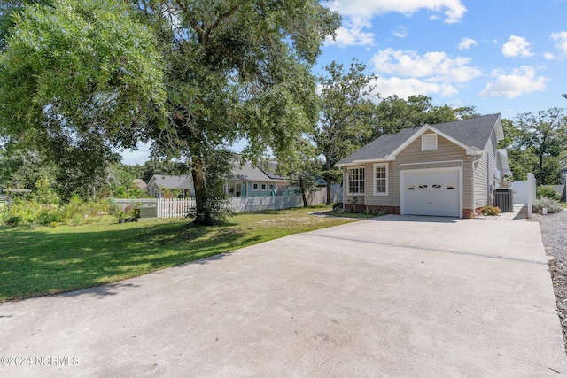 ranch-style home featuring a garage and a front lawn