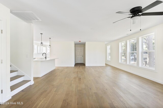 spare room featuring light hardwood / wood-style flooring and ceiling fan