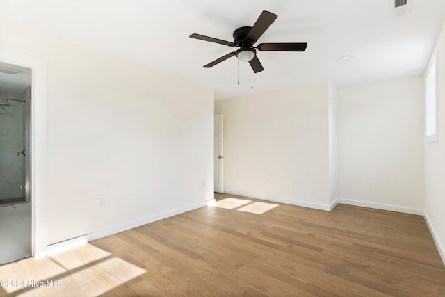 spare room with wood-type flooring and ceiling fan