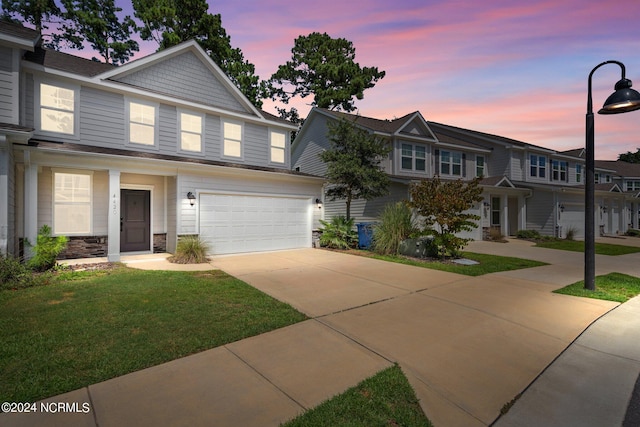 view of front of home featuring a yard and a garage