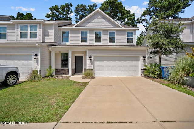 view of front of house featuring a front yard and a garage