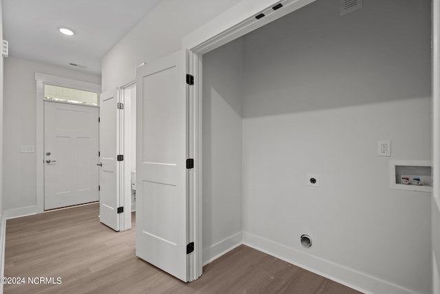 clothes washing area featuring washer hookup, hookup for an electric dryer, and light hardwood / wood-style flooring