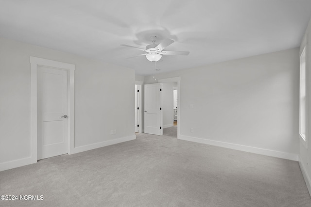 carpeted empty room with ceiling fan