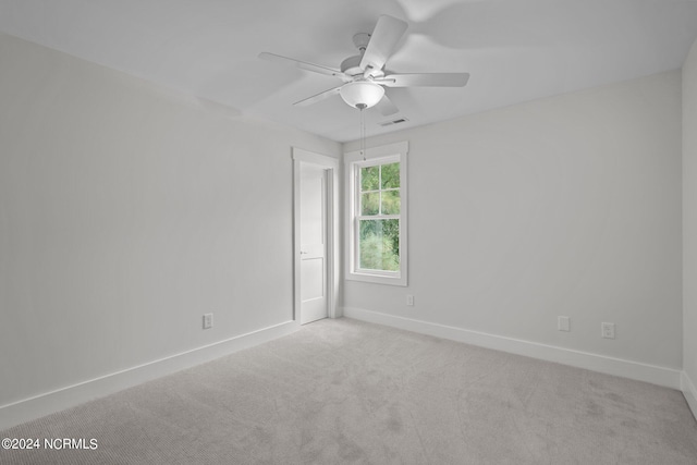 spare room featuring ceiling fan and light colored carpet