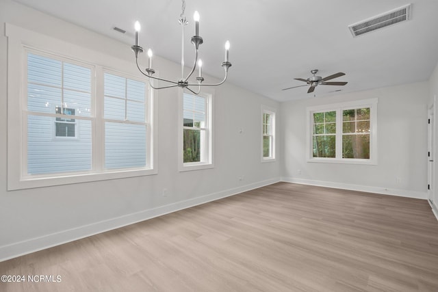 unfurnished room featuring light hardwood / wood-style flooring and ceiling fan with notable chandelier