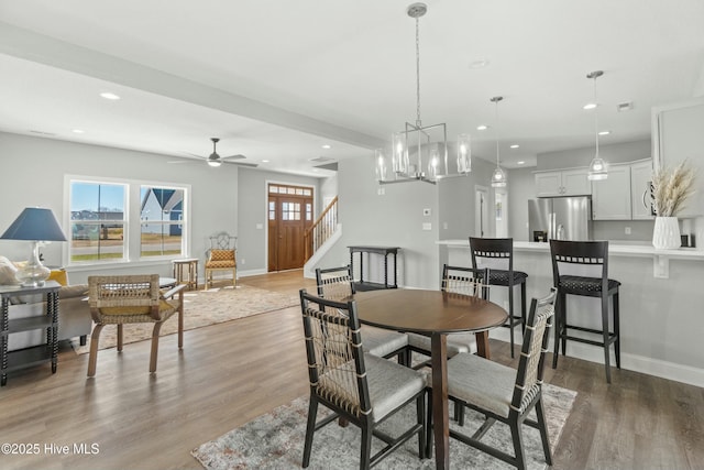 dining room featuring wood-type flooring and ceiling fan