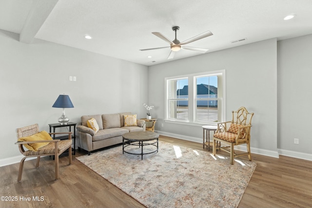 living room featuring hardwood / wood-style flooring and ceiling fan