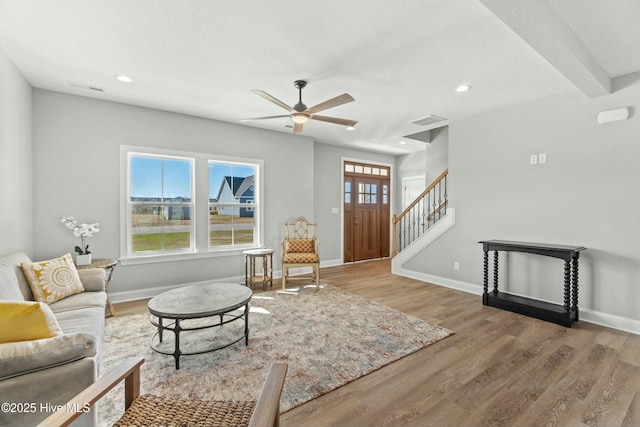 living room with ceiling fan and hardwood / wood-style floors