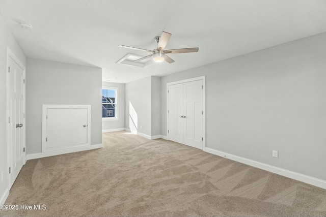 unfurnished bedroom featuring ceiling fan, a closet, and light carpet