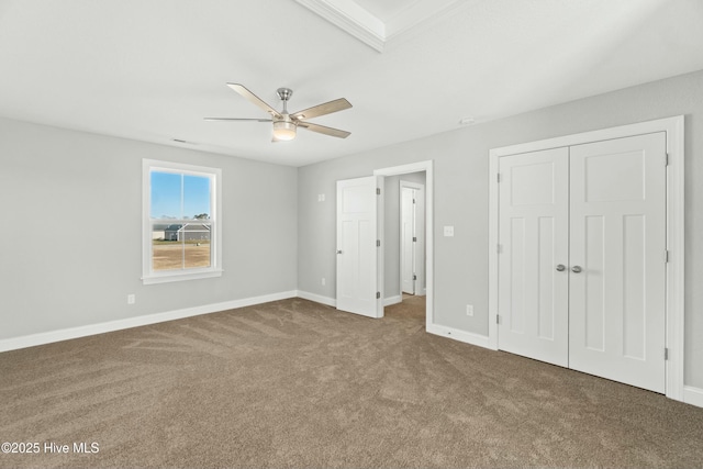 unfurnished bedroom featuring ceiling fan, carpet flooring, and a closet